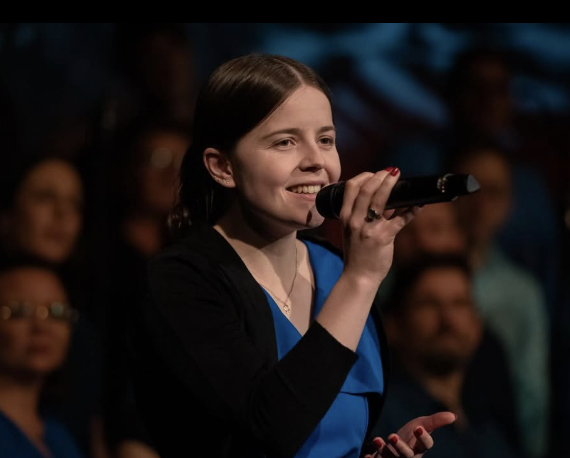 Alina singing into a microphone